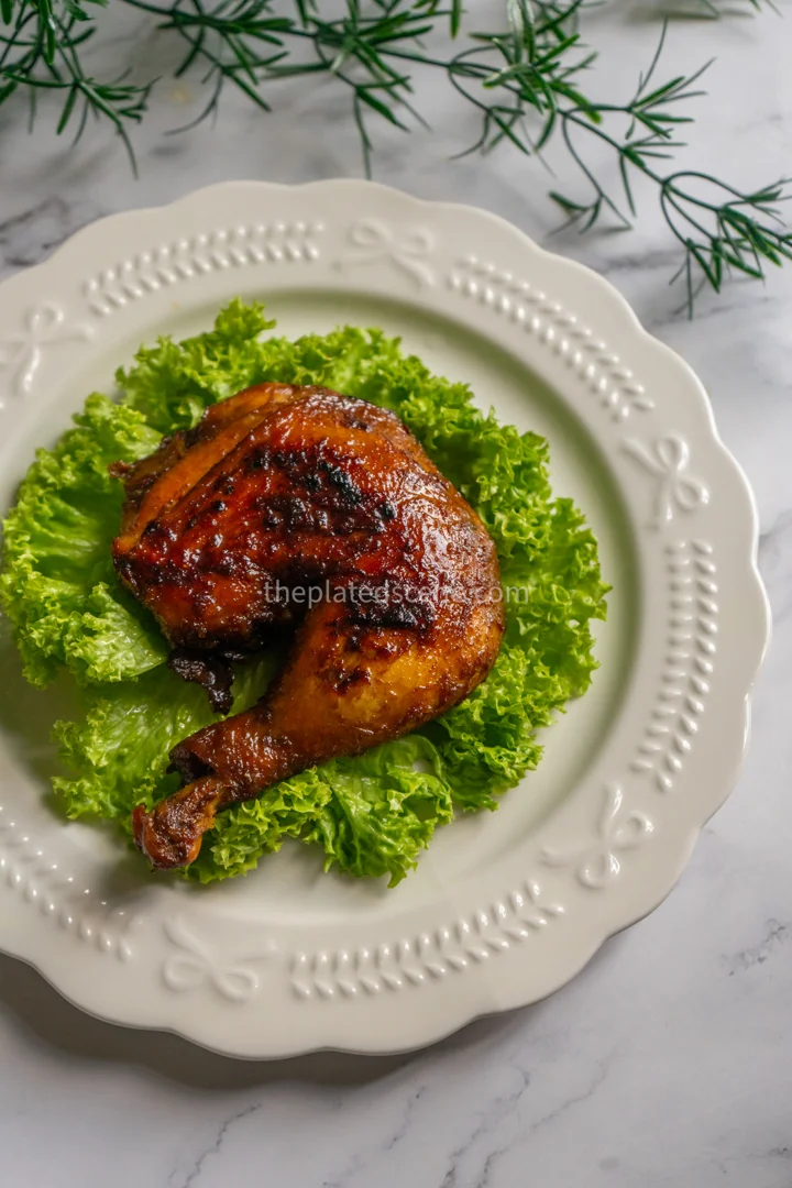 Ayam Bakar: Authentic Indonesian Grilled Chicken Recipe 4 Golden grilled ayam bakar chicken with beautiful char marks served on banana leaf