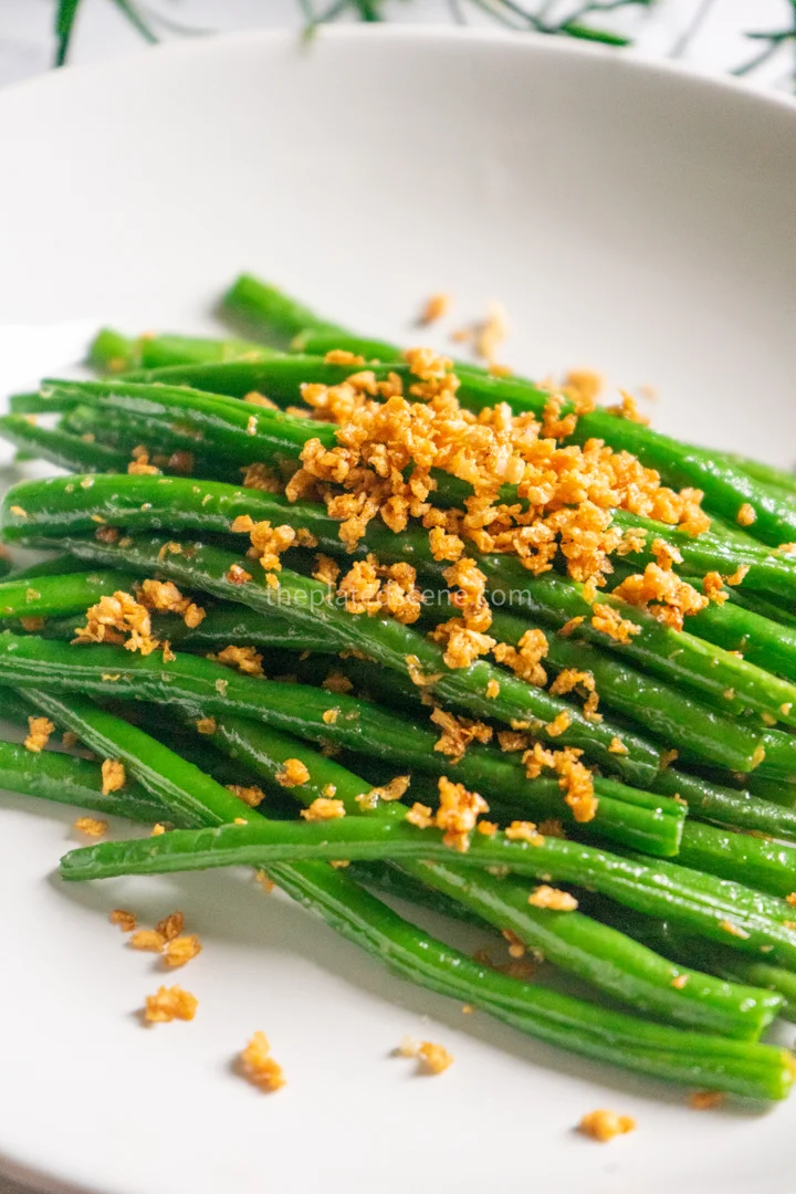 Green Beans with Garlic: Easy 15-Minute Side Dish 11 green beans with garlic served alongside steamed rice and other Indonesian dishes