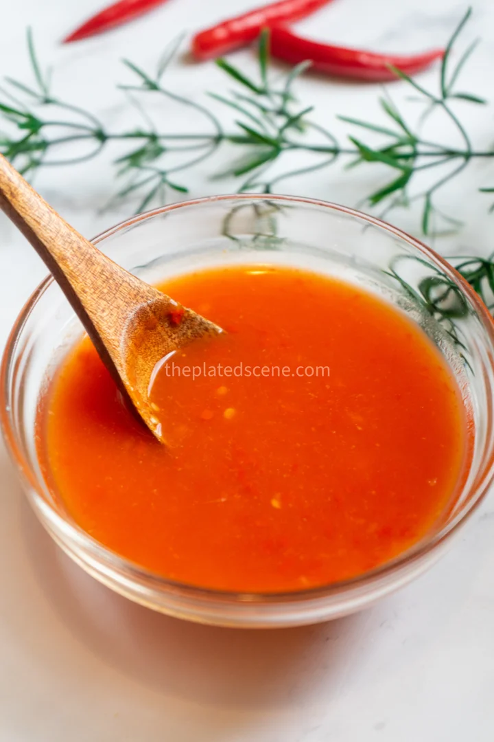 Dimsum Sauce Recipe: Sweet & Savory Dipping Sauce 10 Dimsum sauce being drizzled over steamed dumplings showing perfect consistency