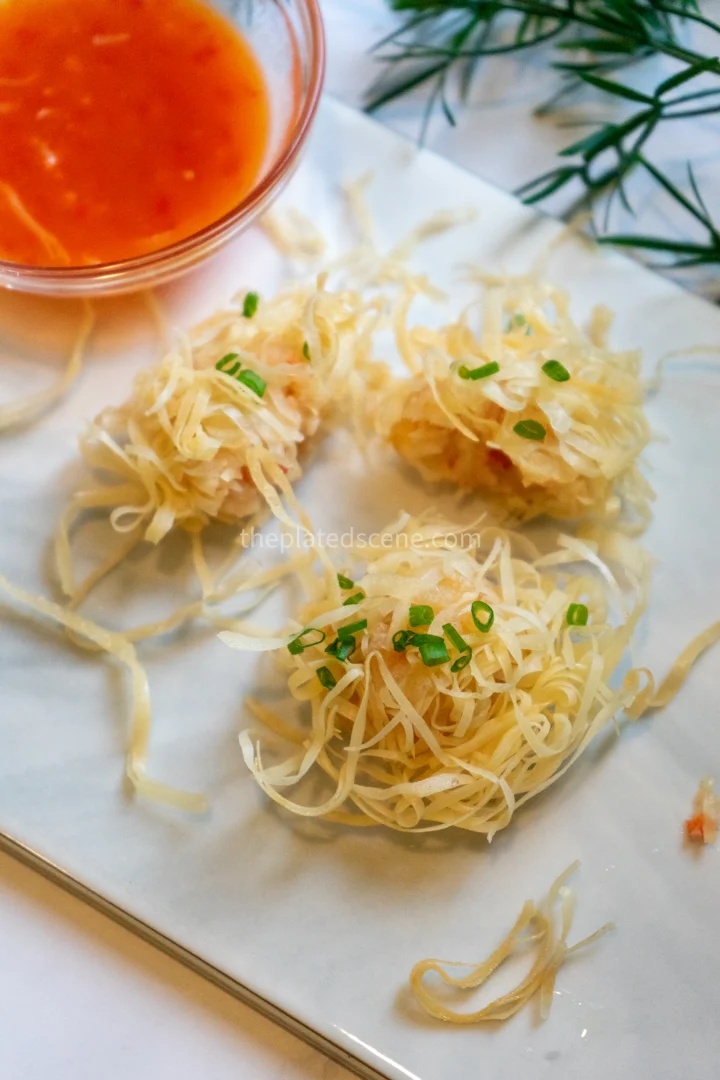 Udang Rambutan: Indonesian Crispy Prawn Balls 4 Golden crispy udang rambutan arranged on a white plate with dipping sauce